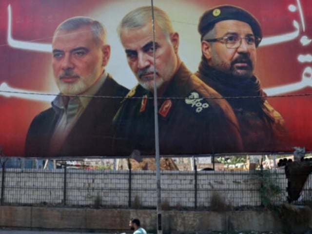 a man rides his moped past a billboard bearing portraits of slain leaders ismail haniyeh of the palestinian militant group hamas iranian quds force chief qasem soleimani c and hezbollah senior commander fuad shukr on the main road near the beirut international airport on august 3 2024 photo afp